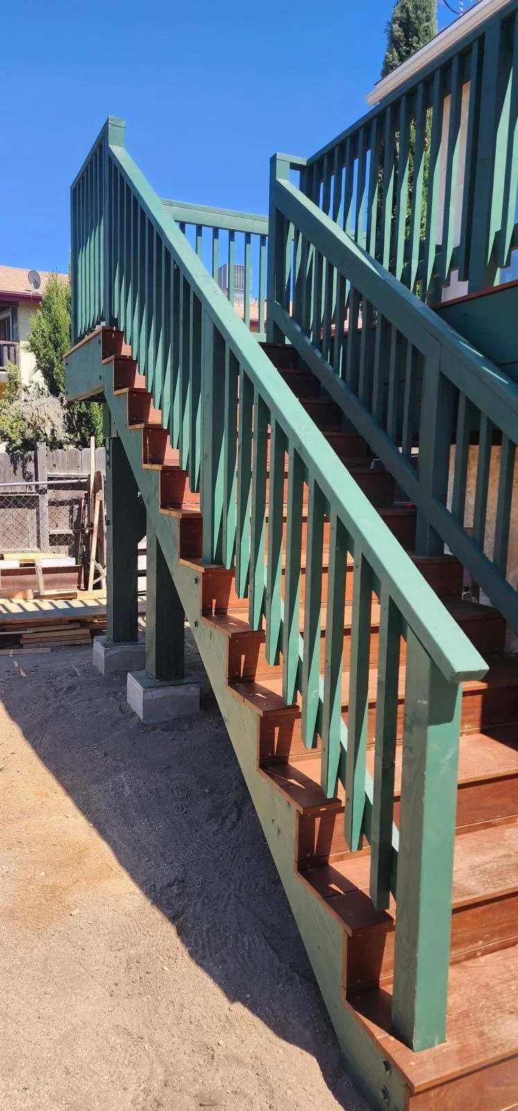 Green railed deck with wooden stairs and composite railings in Cape Coral